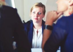 Three people in a meeting.