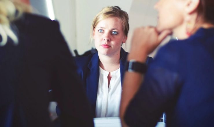 Three people in a meeting.