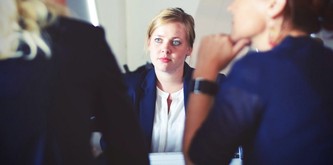 Three people in a meeting.